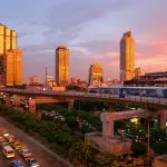 BTS Skytrain above evening traffic in Bangkok