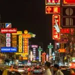 Neon signs and traffic on Yaowarat Road in Bangkok at night