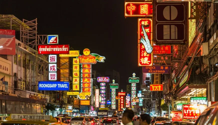 Neon signs and traffic on Yaowarat Road in Bangkok at night