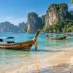 Long-tail boats on a clear Andaman beach during the dry season in Thailand