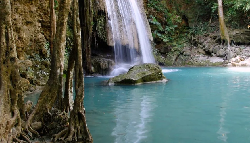 Turquoise pool and limestone cascade at Erawan Waterfall in Kanchanaburi