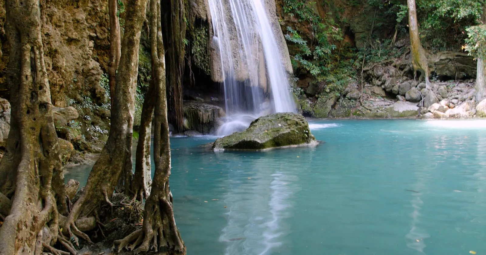 Turquoise pool and limestone cascade at Erawan Waterfall in Kanchanaburi