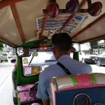 View from the passenger seat of a tuk-tuk in Bangkok traffic