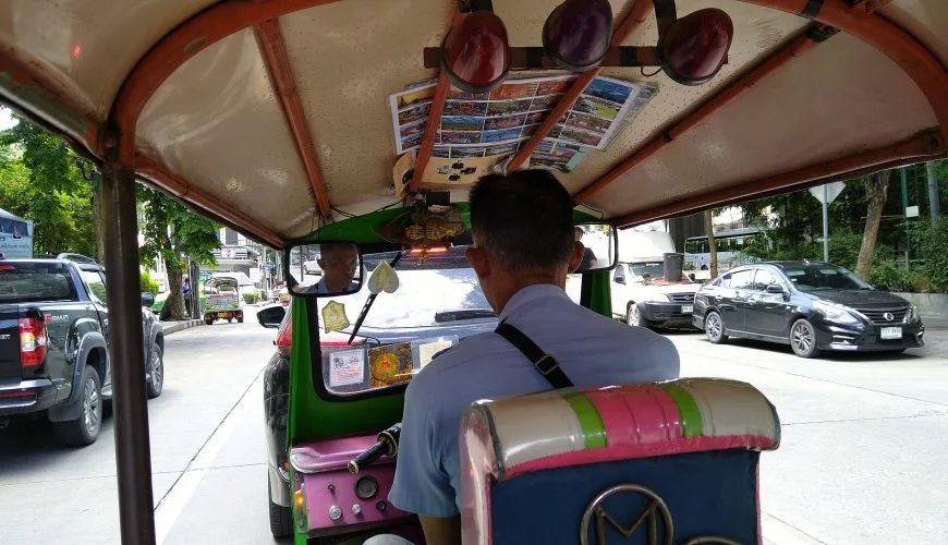 View from the passenger seat of a tuk-tuk in Bangkok traffic