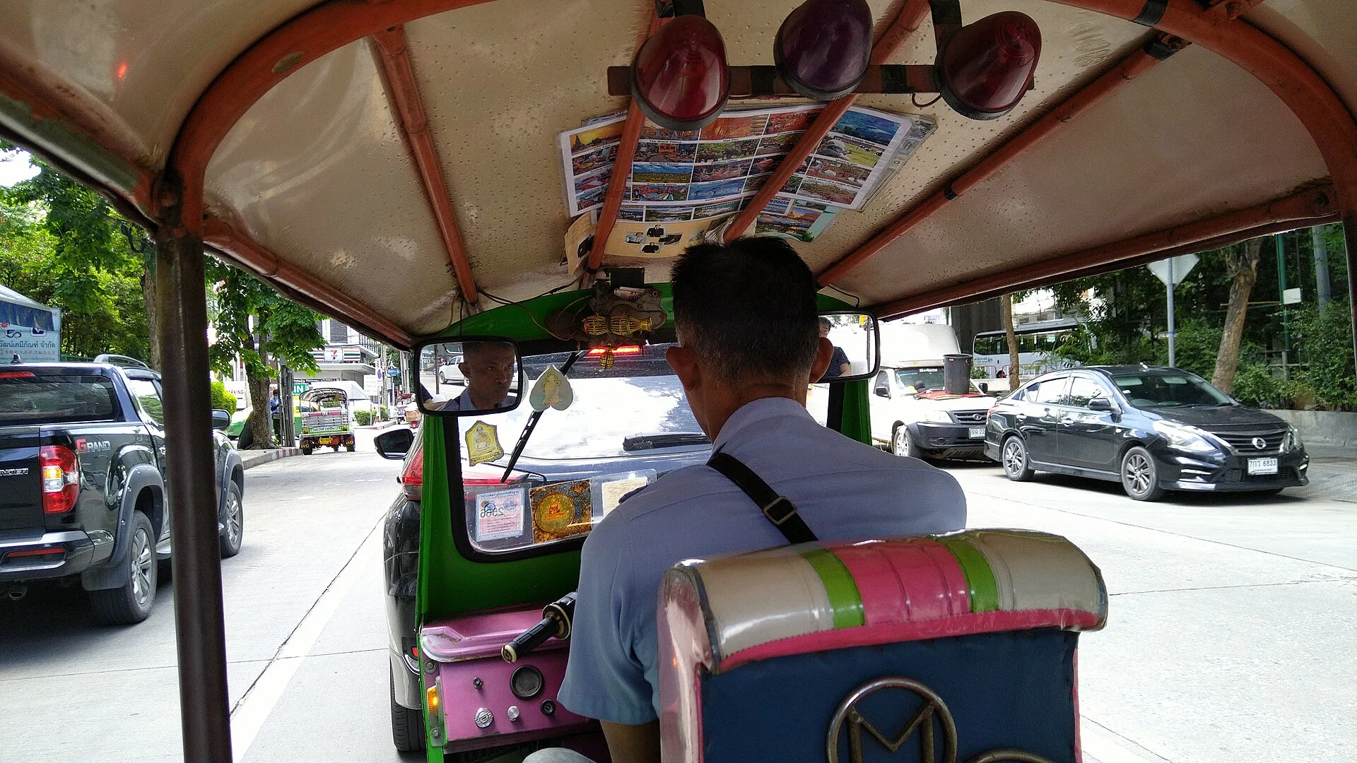 View from the passenger seat of a tuk-tuk in Bangkok traffic