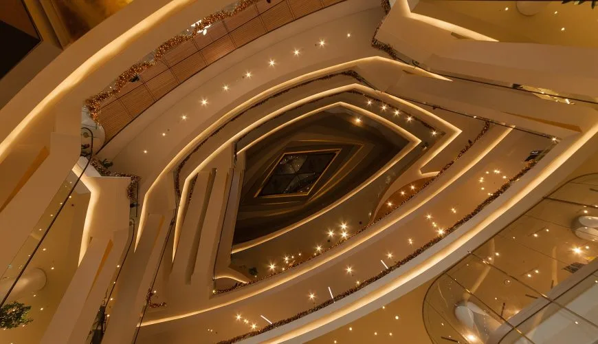 Warmly lit interior atrium of ICONSIAM shopping centre in Bangkok