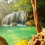 Erawan Waterfall cascading into a green pool in Kanchanaburi