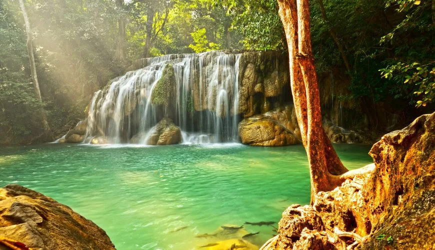 Erawan Waterfall cascading into a green pool in Kanchanaburi