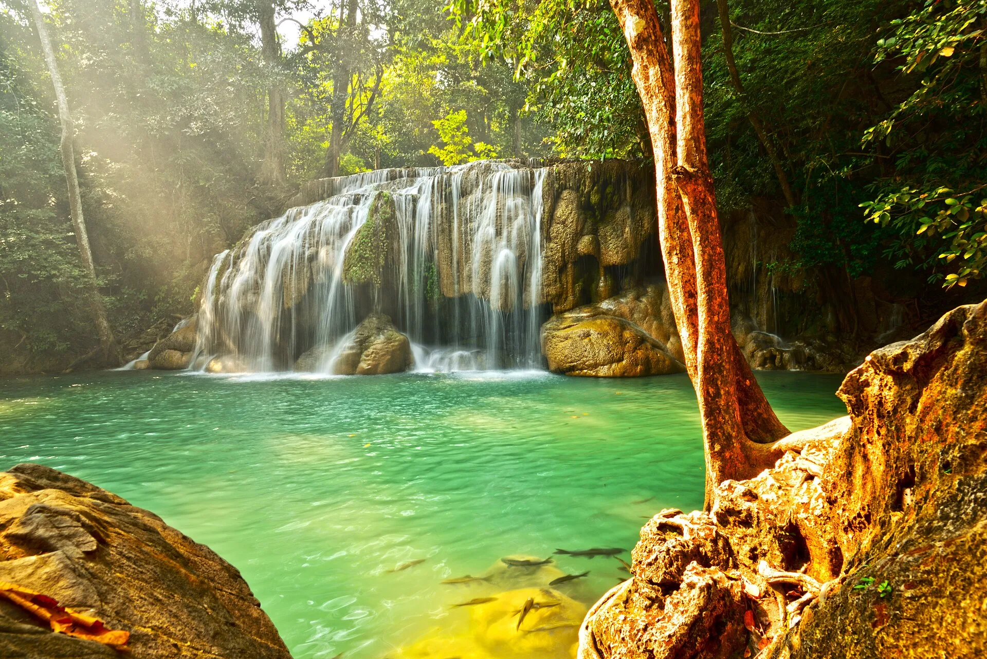 Erawan Waterfall cascading into a green pool in Kanchanaburi