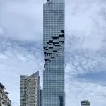 Pixelated façade of King Power Mahanakhon against the Bangkok sky