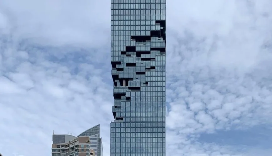 Pixelated façade of King Power Mahanakhon against the Bangkok sky