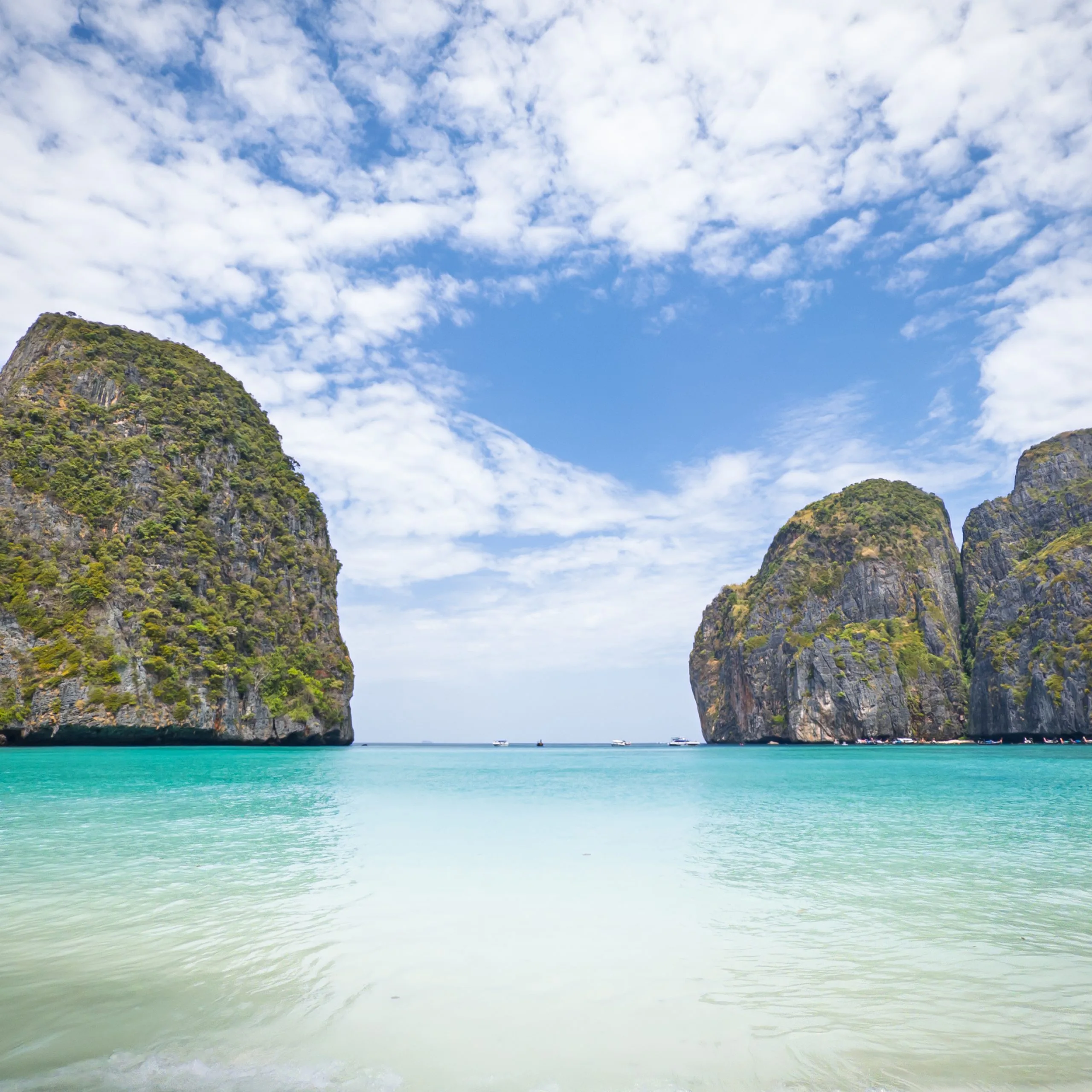 Empty Maya Bay beach framed by limestone cliffs on Phi Phi Leh