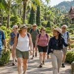 A closed private group walking with a local coordinator through tropical gardens at Nong Nooch near Pattaya