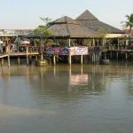 Wooden pavilions and walkways beside the canal at Pattaya Floating Market