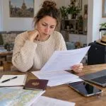 Traveller reviewing travel insurance documents before a trip to Thailand