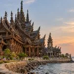 The carved wooden Sanctuary of Truth beside the sea in Pattaya in warm late-afternoon light