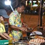 Thai cooks preparing stir-fried dishes at a Sattahip night market