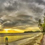 Couple walking together on a tropical beach in Thailand