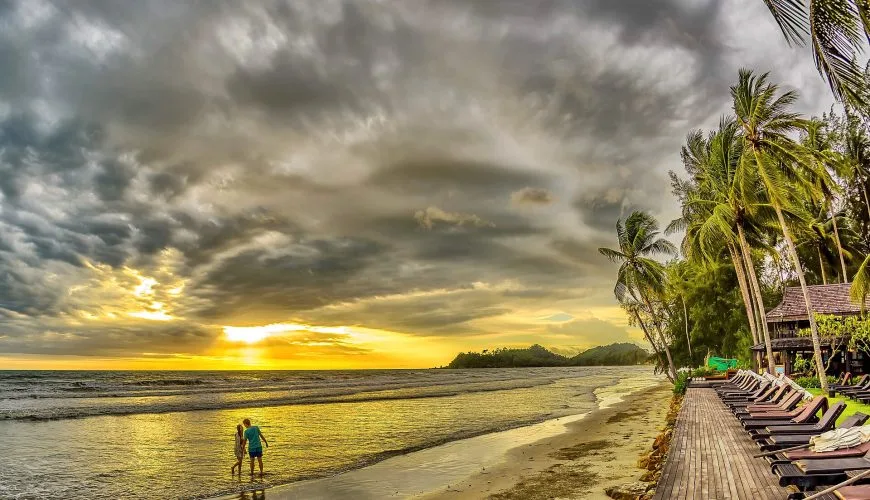 Couple walking together on a tropical beach in Thailand
