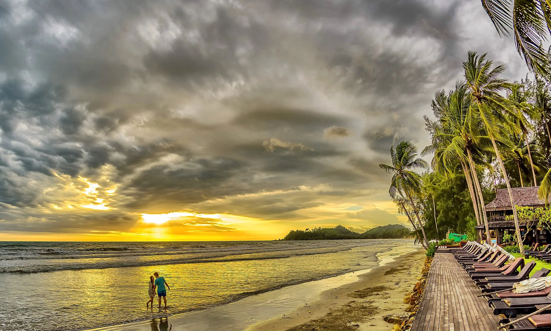 Couple walking together on a tropical beach in Thailand